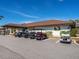 Golf carts parked in front of a community building with vibrant logo at 136 Seaward Way, North Port, FL 34287