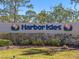 A welcoming sign for the Harbor Isles community, framed by manicured greenery at 136 Seaward Way, North Port, FL 34287