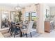 Bright dining room with wooden table, chairs, and large mirror at 1422 Powell Valley Dr, Port Charlotte, FL 33953