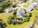 Aerial view of a single-Gathering home with screened pool and lush landscaping at 154 Catamaraca Ct, Punta Gorda, FL 33983