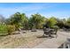 Relaxing backyard area featuring seating around a fire pit surrounded by lush tropical landscaping at 154 Catamaraca Ct, Punta Gorda, FL 33983