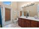 Bathroom featuring a large mirror, dark wood cabinets, shower, and natural light at 154 Catamaraca Ct, Punta Gorda, FL 33983