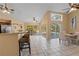 View of kitchen, breakfast bar, and dining area with access to the pool at 154 Catamaraca Ct, Punta Gorda, FL 33983