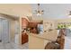 Kitchen and breakfast bar features dark wood cabinetry, stainless appliances and tile floors at 154 Catamaraca Ct, Punta Gorda, FL 33983