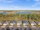 Aerial view of a row of houses with gray roofs and green lawns at 17638 Palmetto Pass Ln, Punta Gorda, FL 33982