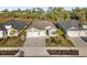 Aerial view of two-story house with light beige exterior and two-car garage at 17638 Palmetto Pass Ln, Punta Gorda, FL 33982