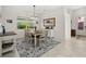 Dining room with a wood table, chandelier, and area rug at 17638 Palmetto Pass Ln, Punta Gorda, FL 33982