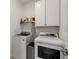 Laundry room with washer, dryer and overhead cabinets at 17638 Palmetto Pass Ln, Punta Gorda, FL 33982