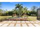 Landscaped backyard with palm trees and stone path at 1785 Nagorsky Ave, North Port, FL 34288