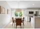 Kitchen dining area with wooden table, wicker chairs, and view of backyard at 1785 Nagorsky Ave, North Port, FL 34288