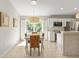 Kitchen dining area with wooden table, wicker chairs, and view of backyard at 1785 Nagorsky Ave, North Port, FL 34288