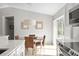 Bright dining area with wooden table, wicker chairs, and view of backyard at 1785 Nagorsky Ave, North Port, FL 34288