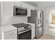 Bright kitchen with stainless steel appliances and white cabinets at 1785 Nagorsky Ave, North Port, FL 34288