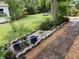 Landscaped backyard with brick pathway, lush greenery, and a shed at 18085 Wintergarden Ave, Port Charlotte, FL 33948