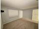 Bright bedroom with carpet flooring, large window, and a double door closet at 18085 Wintergarden Ave, Port Charlotte, FL 33948