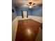 Bedroom with wood-look floors, ceiling fan, and window with curtains at 18085 Wintergarden Ave, Port Charlotte, FL 33948