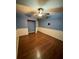 Bedroom with wood-look floors, ceiling fan, and a closet at 18085 Wintergarden Ave, Port Charlotte, FL 33948