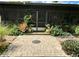 A brick patio area with lush landscaping and screened enclosure at 18085 Wintergarden Ave, Port Charlotte, FL 33948