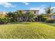 Spacious backyard with home view and palm trees at 1811 Scarlett Ave, North Port, FL 34289