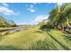 Landscaped backyard with water view and lush grass at 1811 Scarlett Ave, North Port, FL 34289