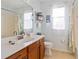 Light and airy bathroom with wood cabinets at 1811 Scarlett Ave, North Port, FL 34289