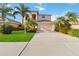 Two-story house with a peach-colored facade, two-car garage, and lush landscaping at 1811 Scarlett Ave, North Port, FL 34289