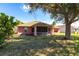 House with large backyard, screened porch, and mature tree at 183 Castile Ct, Punta Gorda, FL 33983