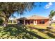 House with large backyard, screened porch, and mature tree at 183 Castile Ct, Punta Gorda, FL 33983