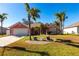 Exterior view of a lovely light pink house with palm trees at 183 Castile Ct, Punta Gorda, FL 33983