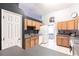 Kitchen features light wood cabinets, gray countertops, and a white refrigerator at 183 Castile Ct, Punta Gorda, FL 33983