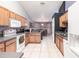 Open kitchen with a view to the dining area, light wood cabinets, and tile floors at 183 Castile Ct, Punta Gorda, FL 33983