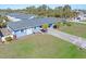 Aerial view of a light blue single-story home with a large yard and palm trees at 1956 Wyoming Ave # 0, Englewood, FL 34224