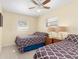 Bedroom with two twin-size beds, ceiling fan and window at 1956 Wyoming Ave # 0, Englewood, FL 34224