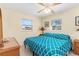 King-size bedroom with teal bedding, ceiling fan and window at 1956 Wyoming Ave # 0, Englewood, FL 34224