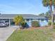 Light blue single story home with carport and palm trees at 1956 Wyoming Ave # 0, Englewood, FL 34224