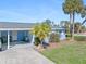 Light blue single story home with carport and palm trees at 1956 Wyoming Ave # 0, Englewood, FL 34224