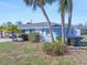 Side view of a light blue home with palm trees and landscaping at 1956 Wyoming Ave # 0, Englewood, FL 34224