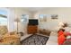 Living room with beige sofa, wicker chair, and a TV at 1956 Wyoming Ave # 0, Englewood, FL 34224