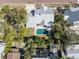 An aerial view of a home's backyard, featuring a pool and a spacious lawn at 227 Harvey St, Punta Gorda, FL 33950