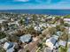 Aerial view of a single story home with a metal roof, situated amongst other houses near the water at 227 Harvey St, Punta Gorda, FL 33950