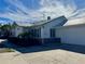 Side view of the house, highlighting the garage and brickwork at 227 Harvey St, Punta Gorda, FL 33950