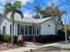 House exterior showcasing a white facade, green accents, and landscaping at 227 Harvey St, Punta Gorda, FL 33950