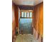 Long hallway with wood walls and floors, showing renovation in progress at 227 Harvey St, Punta Gorda, FL 33950