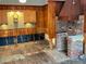 Kitchen with wood cabinets and brick fireplace, awaiting renovation at 227 Harvey St, Punta Gorda, FL 33950