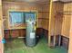 Unfinished laundry room with water heater and storage shelves at 227 Harvey St, Punta Gorda, FL 33950