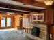 Bright living room featuring hardwood floors, wood walls, and a fireplace at 227 Harvey St, Punta Gorda, FL 33950