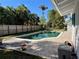 Relaxing kidney-shaped pool with a wooden fence in the background at 227 Harvey St, Punta Gorda, FL 33950