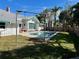 Relaxing pool area with grassy backyard and home in background at 227 Harvey St, Punta Gorda, FL 33950