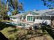 Inviting rectangular pool in the backyard, surrounded by grass at 227 Harvey St, Punta Gorda, FL 33950