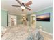 Bright bedroom with a king bed, ensuite bath, and large TV at 2358 El Cerito Ct, Punta Gorda, FL 33950